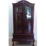 A modern mahogany display cabinet with two glazed doors and a drawer, raised on cabriole legs  75"h