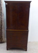 A 1930s design walnut finished cocktail cabinet, the upper part enclosed by a pair of doors, over