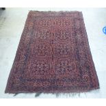 A Persian rug, decorated with repeating stylised designs, on a multi-coloured ground  52" x 80"