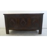 An early 18thC panelled oak coffer with straight sides and a hinged lid, raised on block feet  27"h
