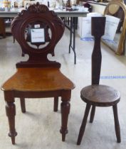 A mid Victorian mahogany hall chair; and an Arts & Crafts oak spinning chair