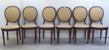 A set of six early 20thC French inspired mahogany showwood framed dining chairs, raised on