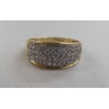 A 9ct gold wide band, set with a multitude of diamonds  boxed
