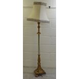 A modern carved white and gilt painted standard lamp  52"h