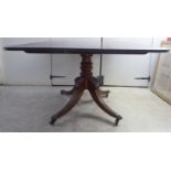 An early/mid 19thC mahogany pedestal breakfast table, raised on a stylised, quadruped base  30"h