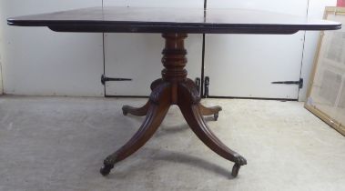 An early/mid 19thC mahogany pedestal breakfast table, raised on a stylised, quadruped base  30"h