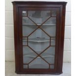 A late 19thC mahogany corner cabinet with a glazed door, on a plinth  39"h  28"w