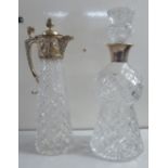 A clear glass decanter with a silver collar and stopper  Birmingham 1951; and a claret jug with a