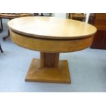 A 1930s Jupe patent oak extending dining table, on a pedestal base  30"h  47"dia
