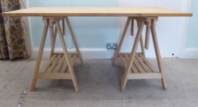 A modern stained beech work table, raised on trestle ends  30"h  62"L