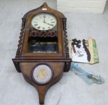 A late 19thC mahogany and walnut veneered wall clock; the 8 day movement faced by a Roman dial  36"h