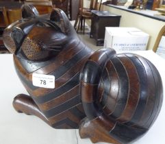 A modern carved wooden figure, a seated cat with a hidden compartment in the base  8"h  10.5"w