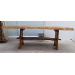 A modern rough sawn planked centre table, raised on a pegged base  18"h  51"w