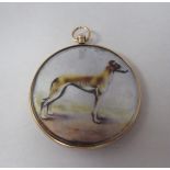 A 9ct gold double-sided, open locket, featuring a picture of a greyhound and another of a young girl