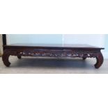 A modern Chinese fruitwood coffee table, raised on curved legs  13"h  58"w