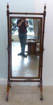 An early 20thC mahogany framed cheval mirror, raised on splayed legs  72"h  29"w