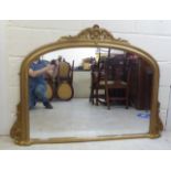 A 20thC overmantel mirror, the plate set in a moulded gilt frame  39" x 54"