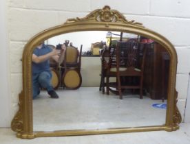 A 20thC overmantel mirror, the plate set in a moulded gilt frame  39" x 54"