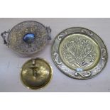 Decorative metalware, viz. an early 20thC brass charger  16"dia; an applique  10"dia; and a twin