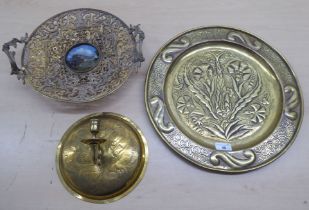 Decorative metalware, viz. an early 20thC brass charger  16"dia; an applique  10"dia; and a twin