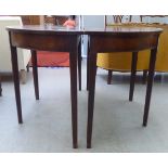 A pair of early 19thC mahogany demi-lune tables, raised on square legs  29"h  48"w