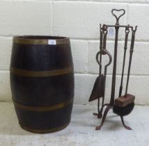 A 19thC coopered oak barrel stickstand  19"h; and a set of four later cast iron fireside companions