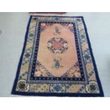 A Chinese rug, decorated with vase motifs, on a blue and peach ground  72" x 48"