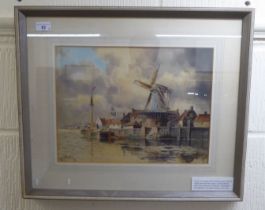 Louis Van Straaten - a Dutch scene, featuring a windmill by a dock  watercolour  bears a