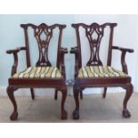 A pair of modern Chippendale design, mahogany framed open arm dining chairs, each with a splat