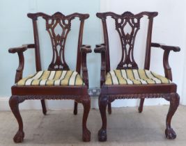 A pair of modern Chippendale design, mahogany framed open arm dining chairs, each with a splat