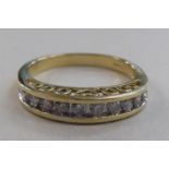 An 14ct gold half-eternity ring, set with a raised band of round cut diamonds  boxed