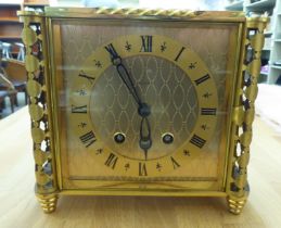 A Luxor lacquered brass cased mantel clock; the 8 day movement faced by a Roman dial  7.5"h  8.5"w