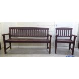A weathered painted teak bench; and a matching armchair  61"w