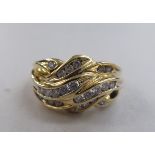 A 14ct gold free-form crossover ring, set with bands of diamonds  boxed
