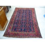 A Persian rug, decorated with repeating stylised designs, on a multi-coloured ground  55" x 88"