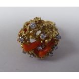 An 18ct gold, coral and diamond set ring of naturalistic form