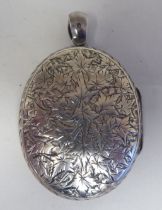 A silver locket, decorated with foliate patterns, on a pendant clasp