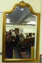 A modern mirror, the shaped bevelled plate, set in a moulded gilt frame  41" x 26"