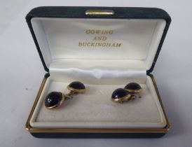 A pair of 9ct gold cufflinks, set with cabochon garnets