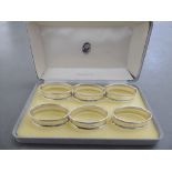 A set of six silver coloured metal oval napkin rings  stamped 925 in a presentation case