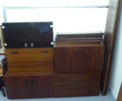 A mid 20thC mahogany finished, five piece modular wall unit with shelves