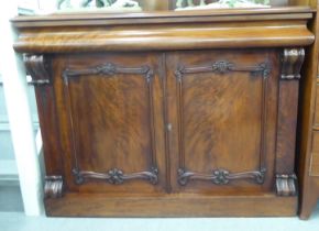 A late Victorian mahogany sideboard with a drawer and two doors, on a plinth  36"h  48"w