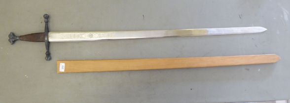 A re-enactment broadsword with a wire bound handgrip and an engraved Torledo blade  40"L in a