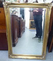 A modern mirror, the bevelled plate set in a moulded gilt frame  35" x 23"