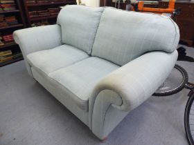 A modern patterned fabric upholstered two person settee, raised on turned forelegs and casters  76"w