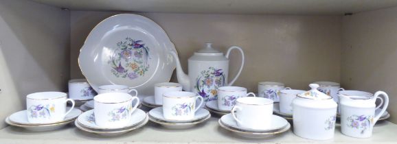 A Limoges porcelain tea set, decorated in gilt trim, birds and floral decoration