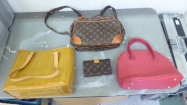 Three dissimilar ladies designer handbags; and a purse