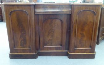 A late Victorian mahogany breakfront sideboard with a drawer and three doors, on a plinth  36"h