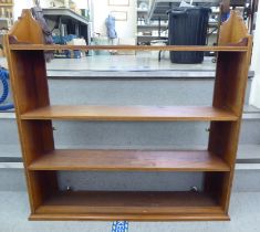 An Edwardian mahogany four tier hanging bookcase  36"h  36"w