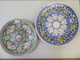 A late 19thC Chinese porcelain famille verte plate, decorated with flora  12"dia; and an early 20thC